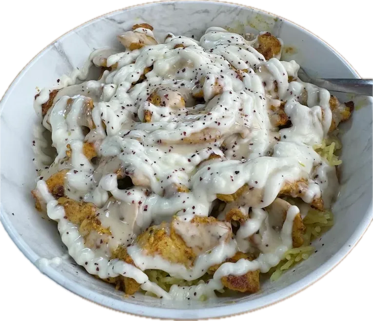 Chicken shawarma over rice, topped with garlic sauce