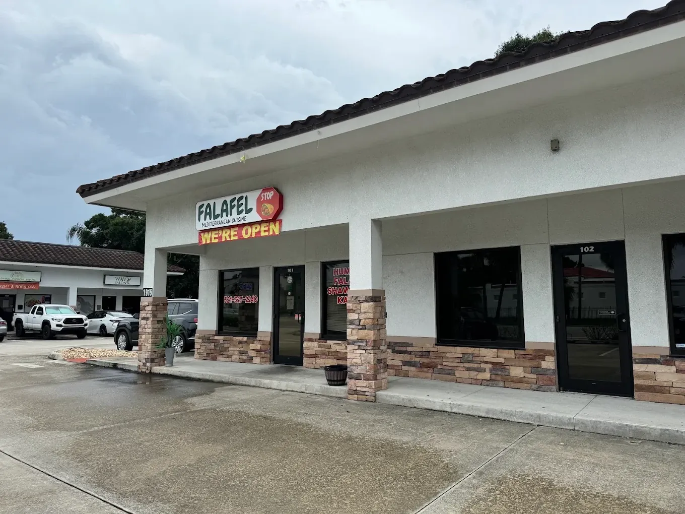 Falafel Stop storefront at 1915 Dr. MLK Jr. Blvd., with the We're Open sign over the door